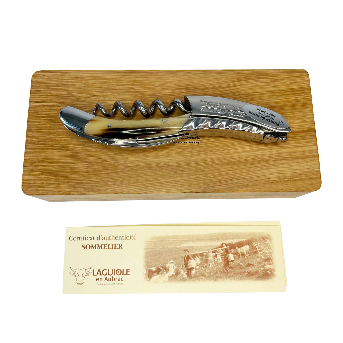 Corkscrew on its oak box with the certificate of authenticity below
