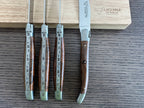 Knives standing upright against the wooden box