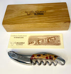 Fuchsia patterned corkscrew in front of its oak box and certificate card