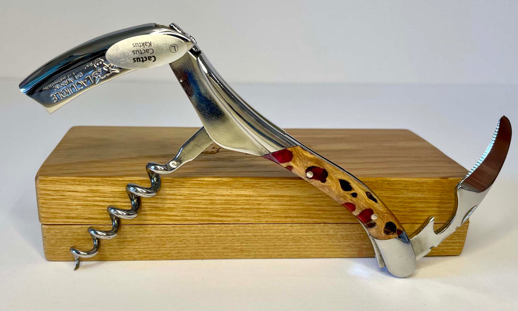 Corkscrew standing open on the oak box with the lever and spiral out