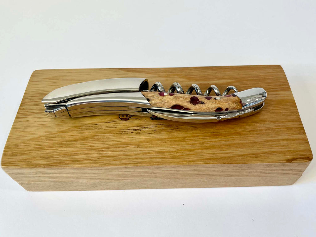Corkscrew resting along the top of the closed oak box
