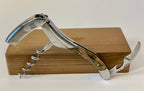 Opened corkscrew standing on the oak box with the lever and spiral out