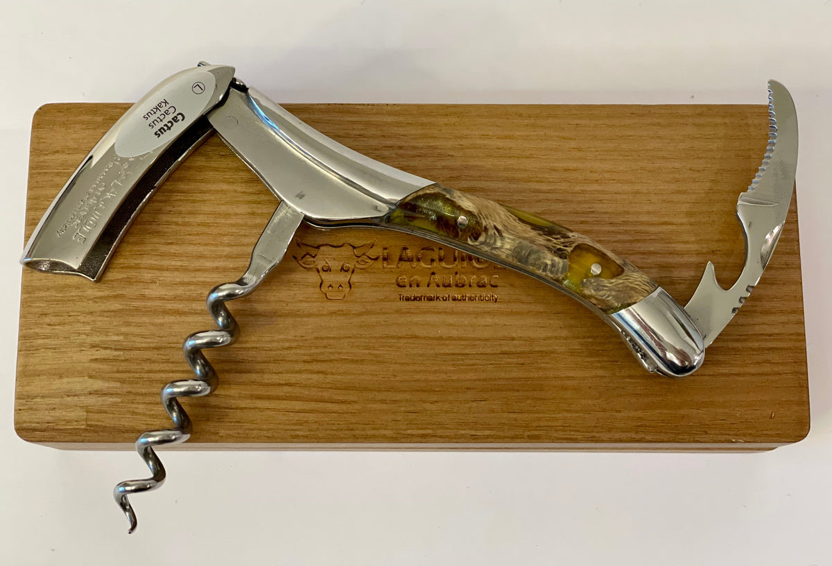Corkscrew laid open across the oak box showing the foil cutter