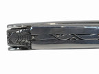 Close view of the carved bee and decorated spine