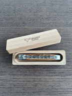 Closed knife in its open wooden storage box