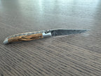 Close view of the Damascus blade and Aubrac wood handle