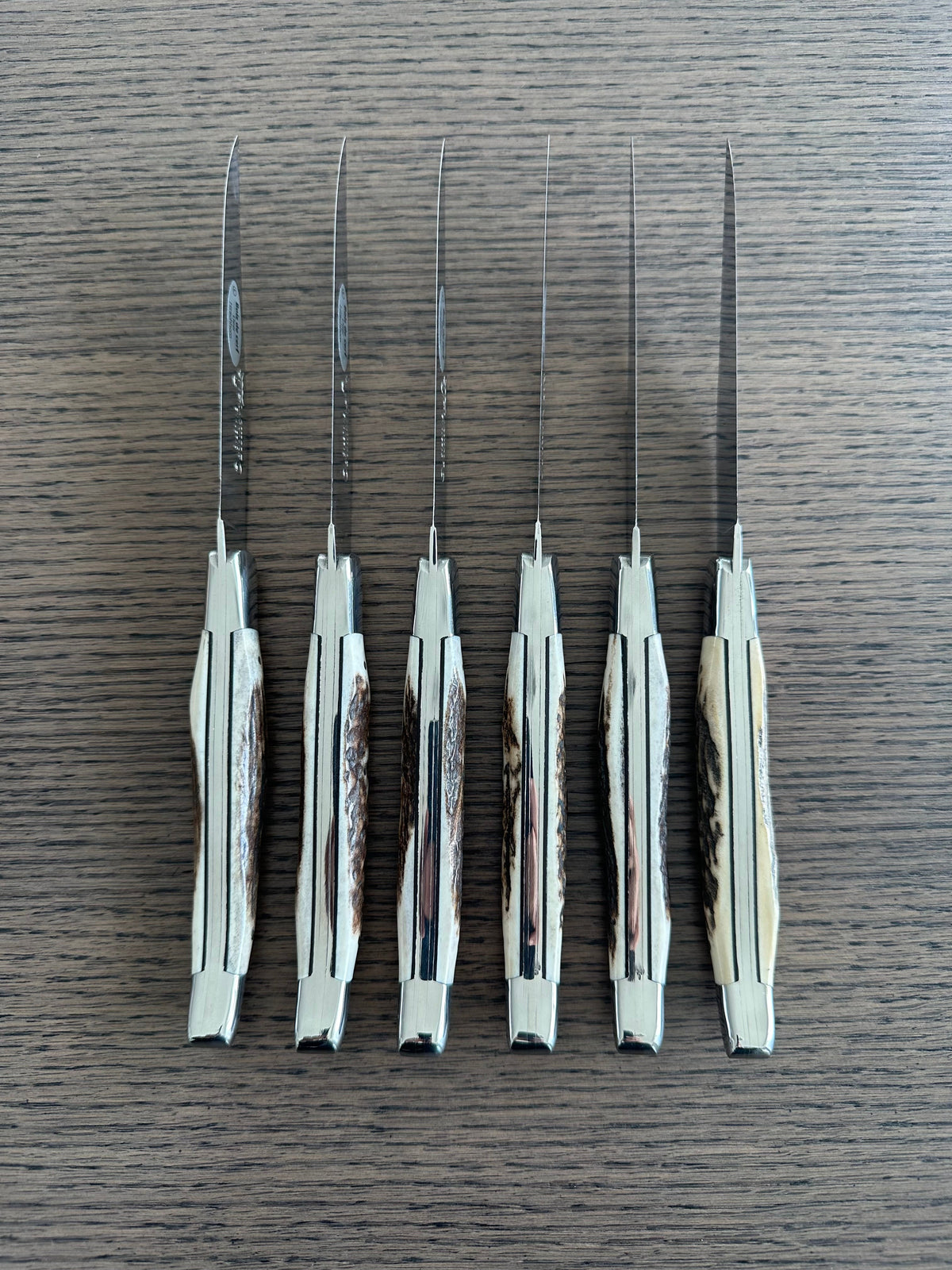 Six knives standing on end showing the antler texture