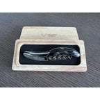 Buffalo horn corkscrew in an open oak gift box on a wood table