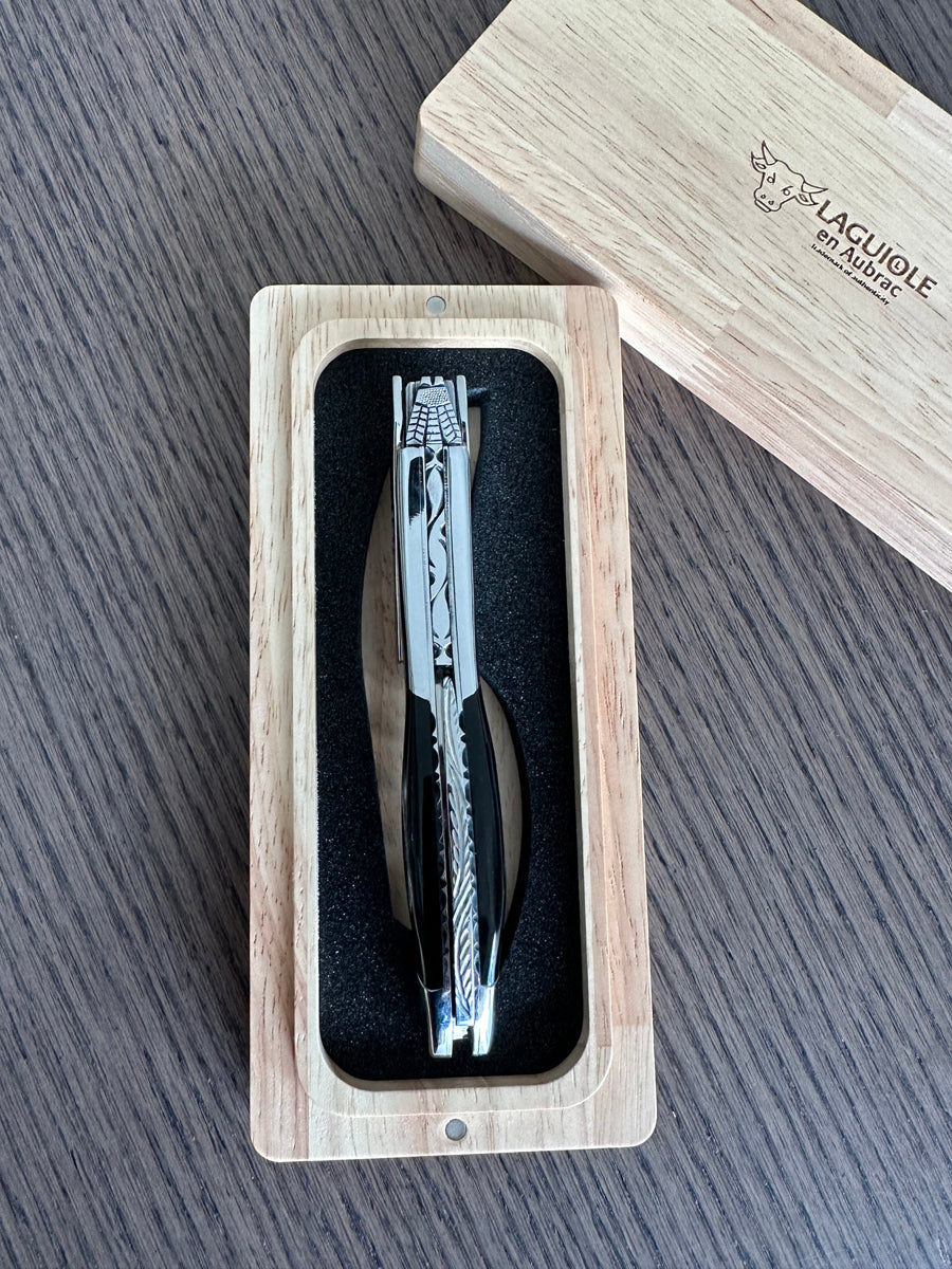 Horn corkscrew in its open box with the lid set behind