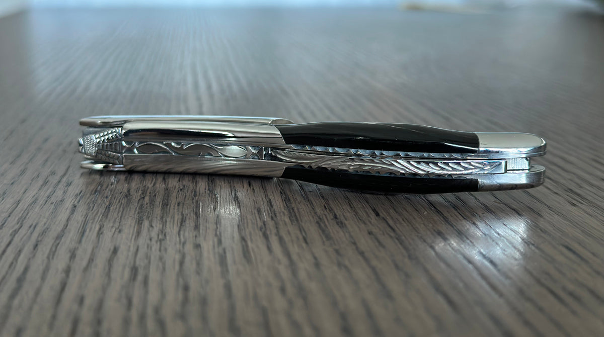 Side view of the folded corkscrew on a wood table