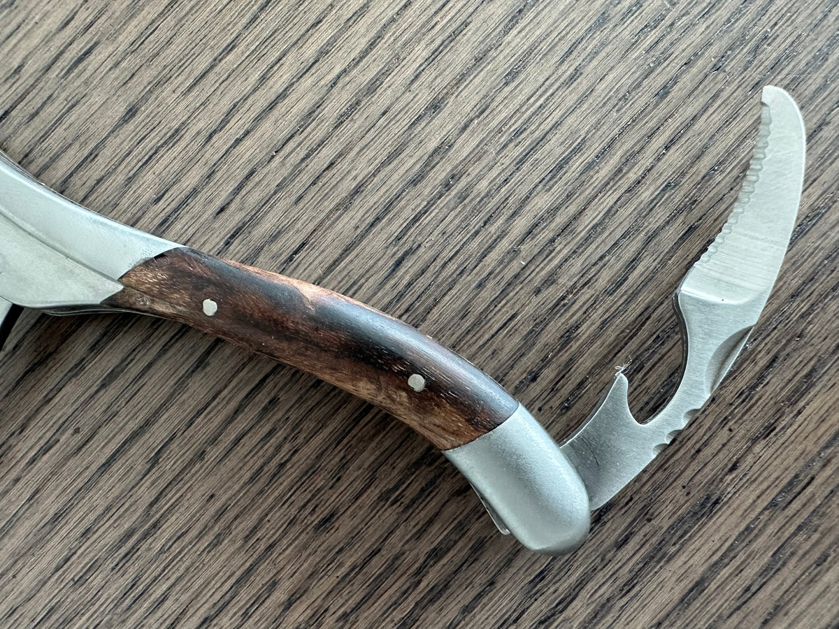 Close view of the dark grapevine wood handle and matte steel lever