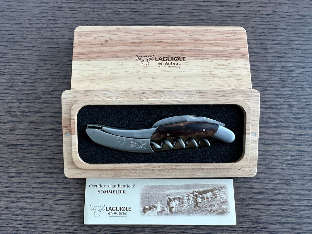 Corkscrew in the oak box with the certificate of authenticity card beside it
