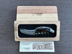 Corkscrew in the oak box with the certificate of authenticity card beside it