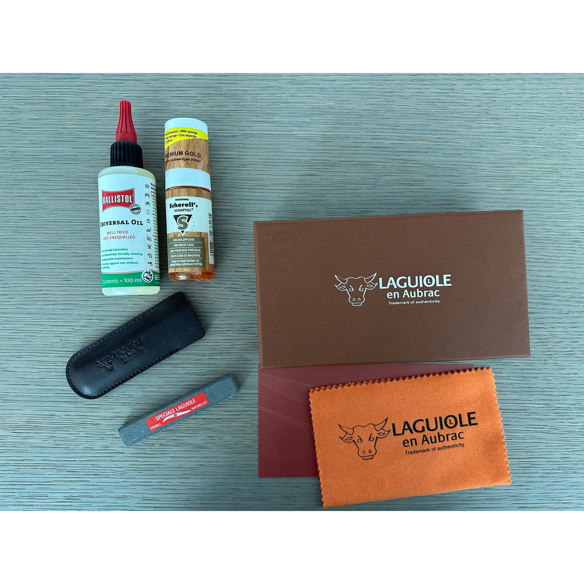 Kit contents laid out beside the brown gift box on a grey surface