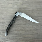 Grey pakka knife half open with the blade pointing right