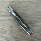 Closed knife lying diagonally showing the worked spine