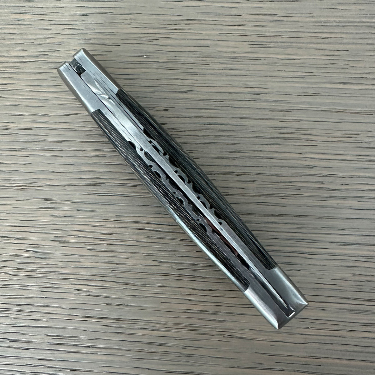Closed knife lying diagonally showing the worked spine