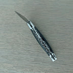 Closed knife at an angle showing the worked back