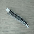 Knife with the Damascus blade folded, horn handle facing up