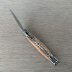 Open knife at an angle with the blade pointing up