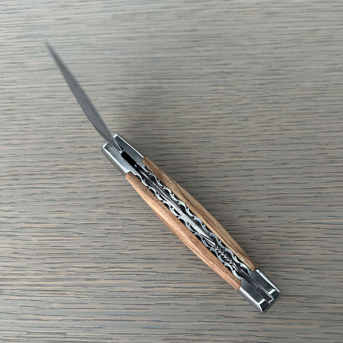 Open knife at an angle with the blade pointing up