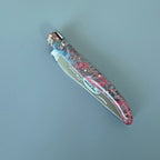 Closed knife showing the blade edge and handle colours