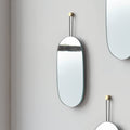 soft oval wall mirror in a powder room