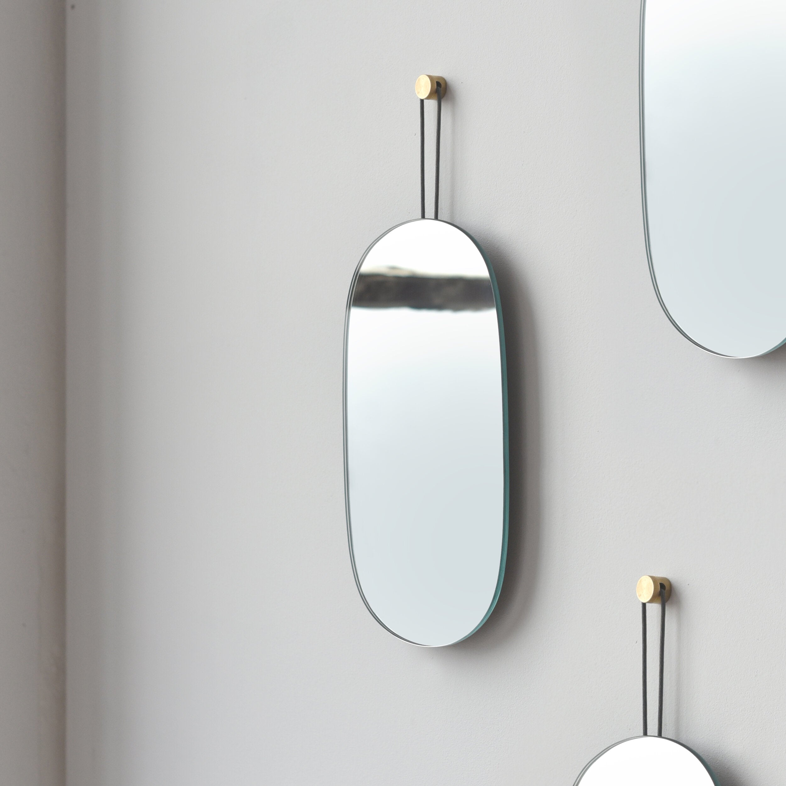 soft oval wall mirror in a powder room