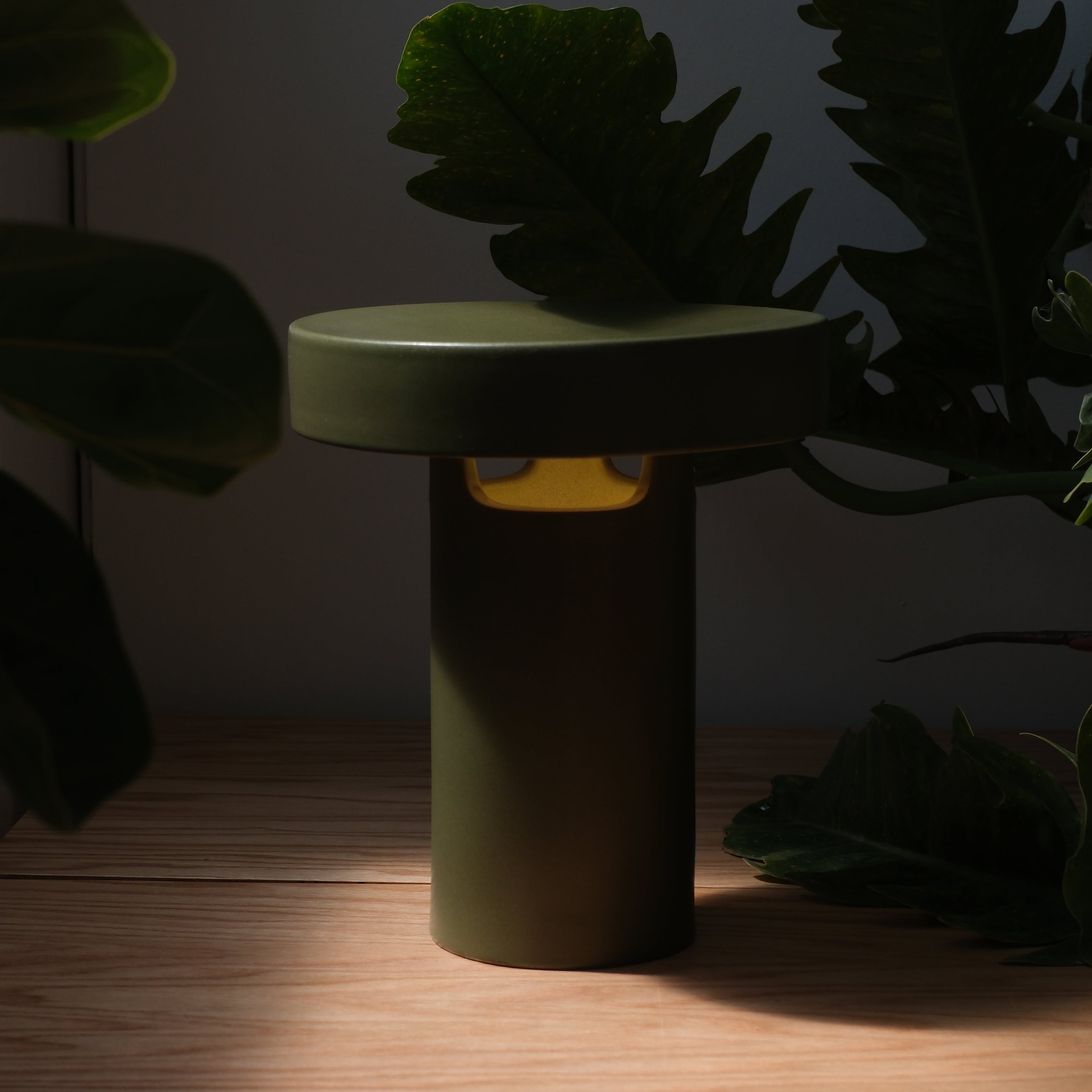 Slot Table Lamp in Pink Glossy on a credenza