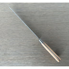Bread knife seen diagonally from the handle end