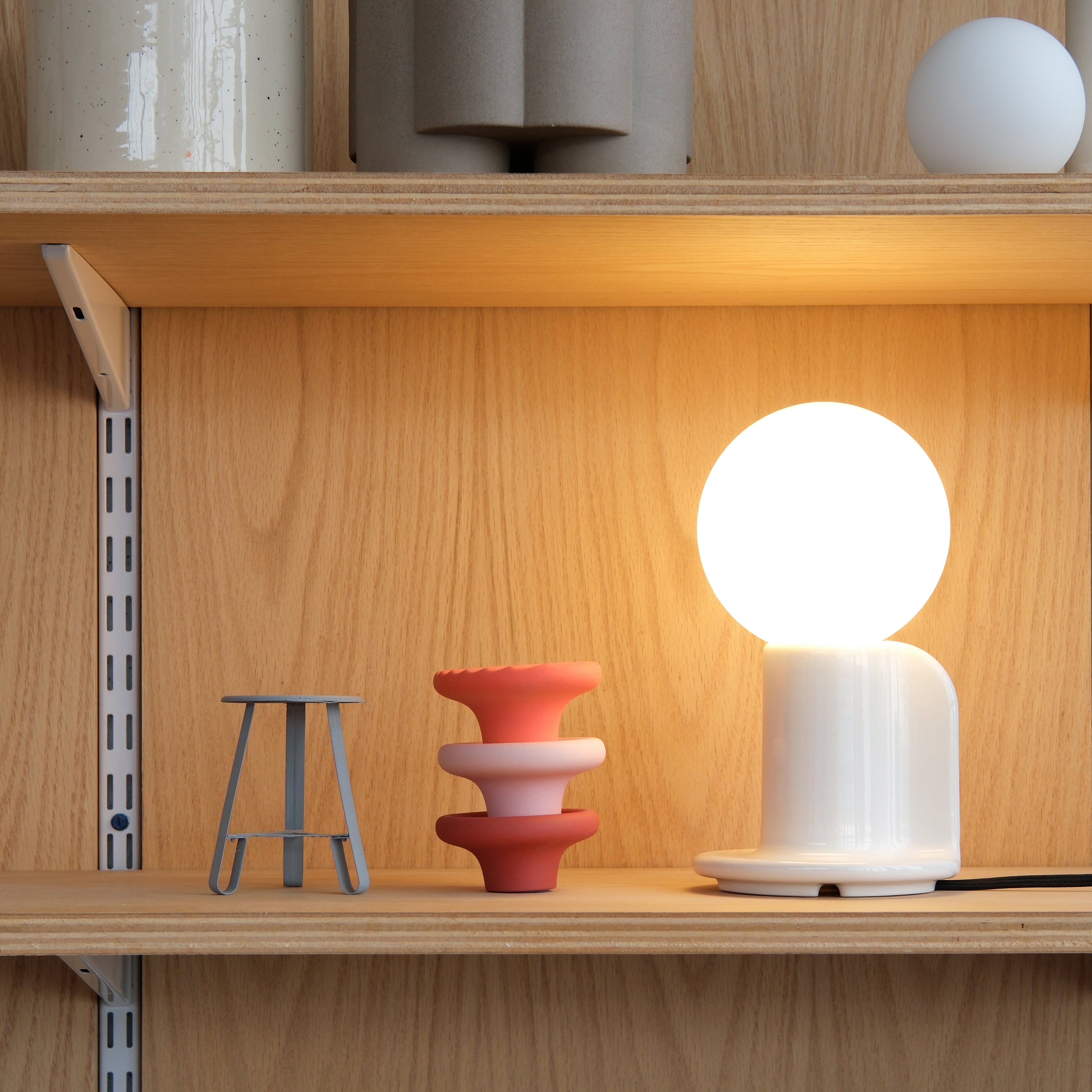 Q Table Lamp in White Glossy on a desk