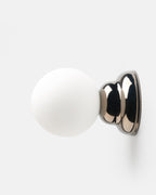 chrome ripple wall sconce above a console
