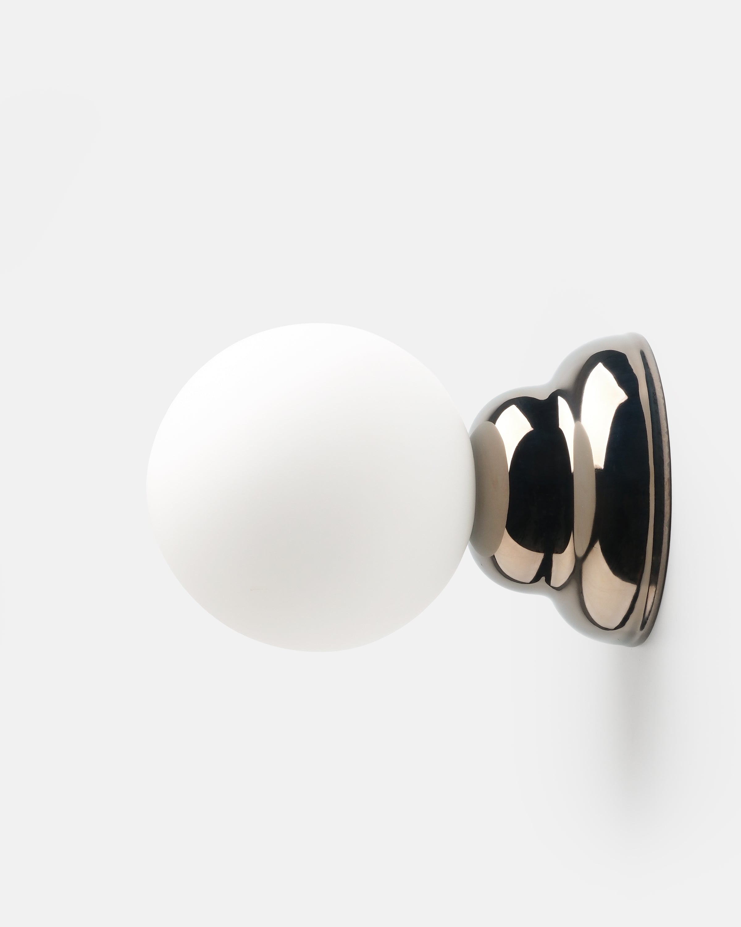 chrome ripple wall sconce above a console