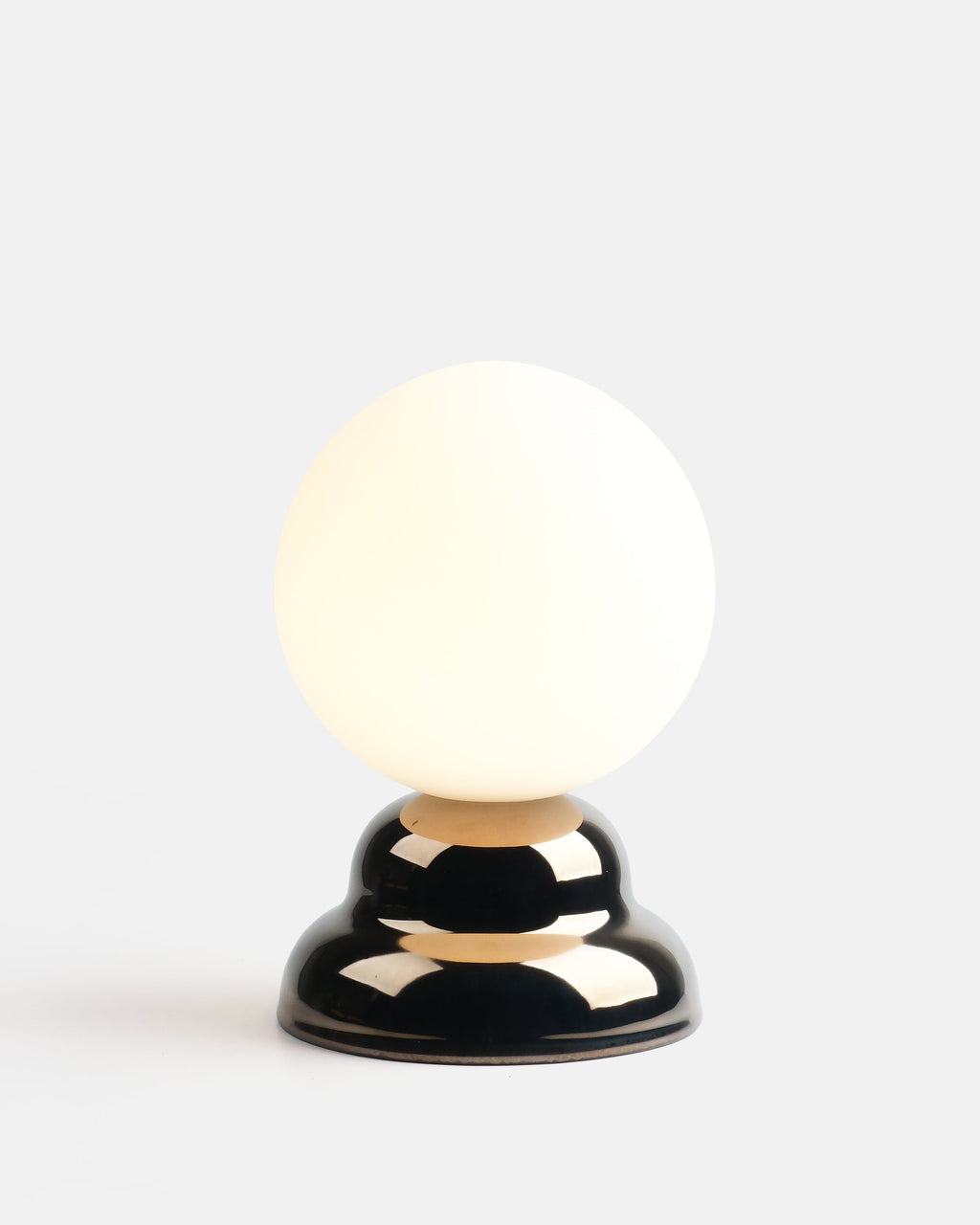 chrome ripple table lamp on a credenza