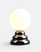 tall chrome ripple table lamp on a nightstand