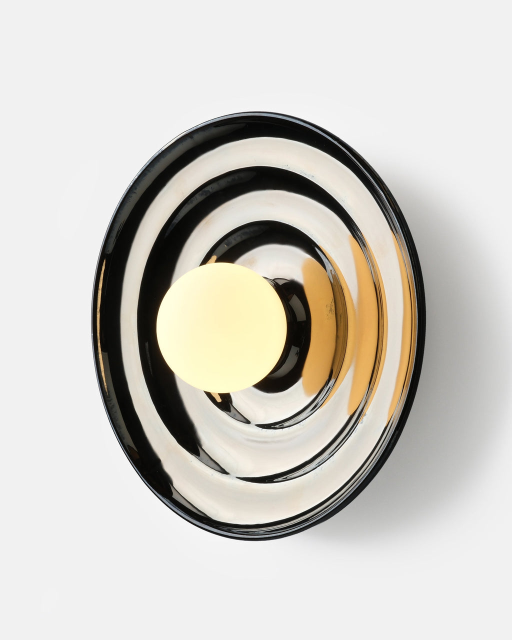 chrome glaze bowl sconce above a console