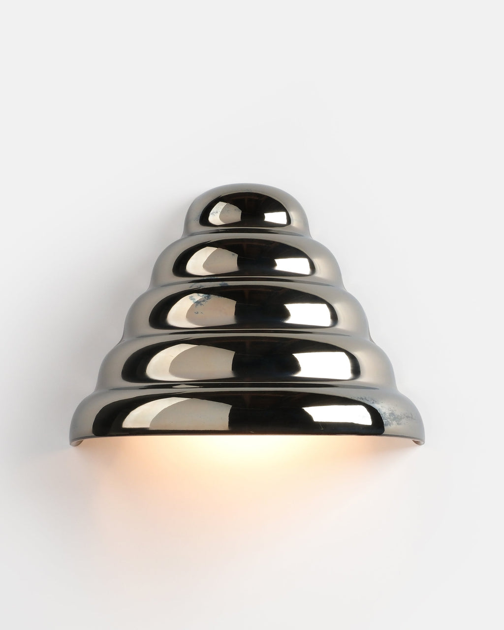 chrome conical ceramic sconce on a hallway wall