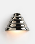 chrome conical ceramic sconce on a hallway wall