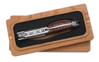 Corkscrew in the box showing the red lined carved spine