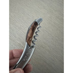 Hand holding the corkscrew with the spiral opened
