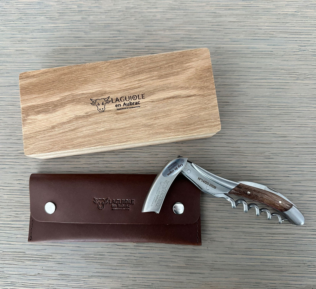 Oak box with the corkscrew resting on its brown leather pouch
