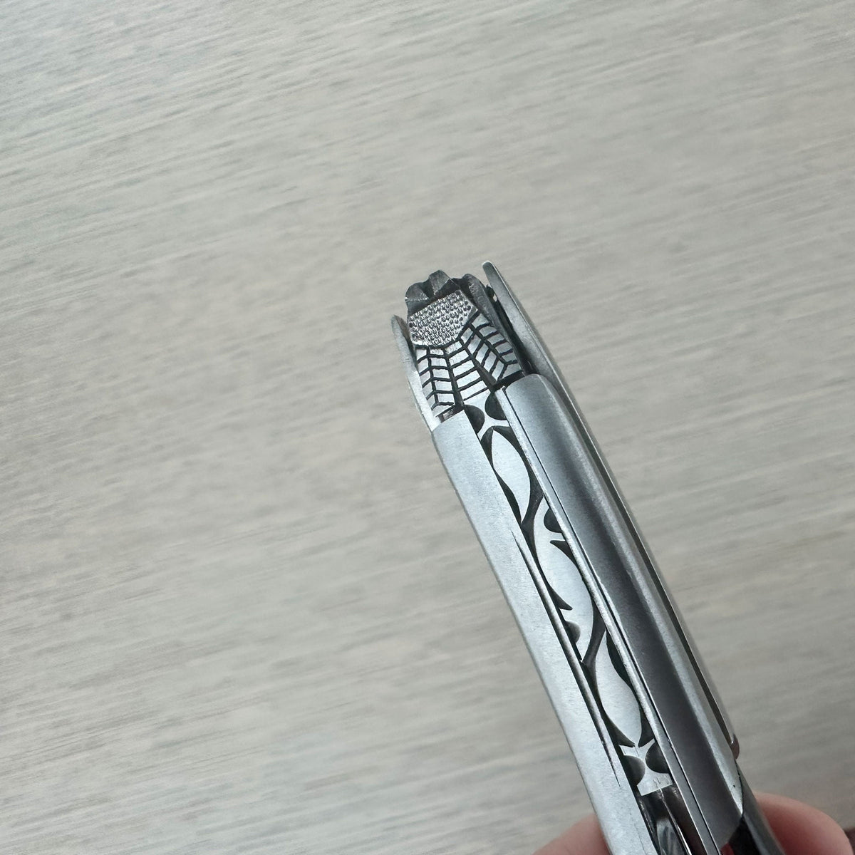 Close view of the carved steel pattern along the top