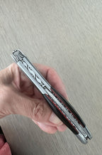 Hand holding the folded corkscrew upright