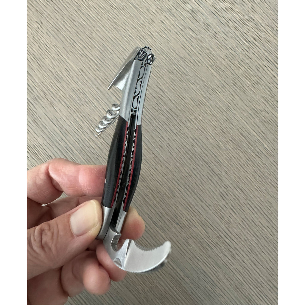 Hand holding the corkscrew with the foil cutter extended