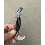 Hand holding the corkscrew with the foil cutter extended