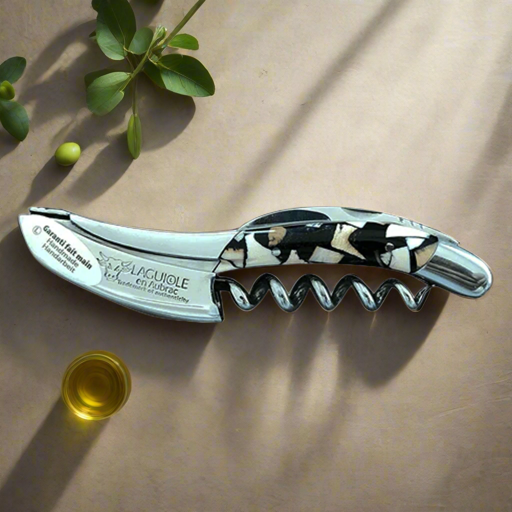 Nougatine corkscrew in soft sunlight beside a small glass of olive oil