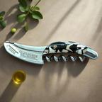 Nougatine corkscrew in soft sunlight beside a small glass of olive oil