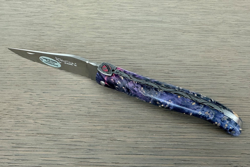 Open knife with the matte blade pointing left