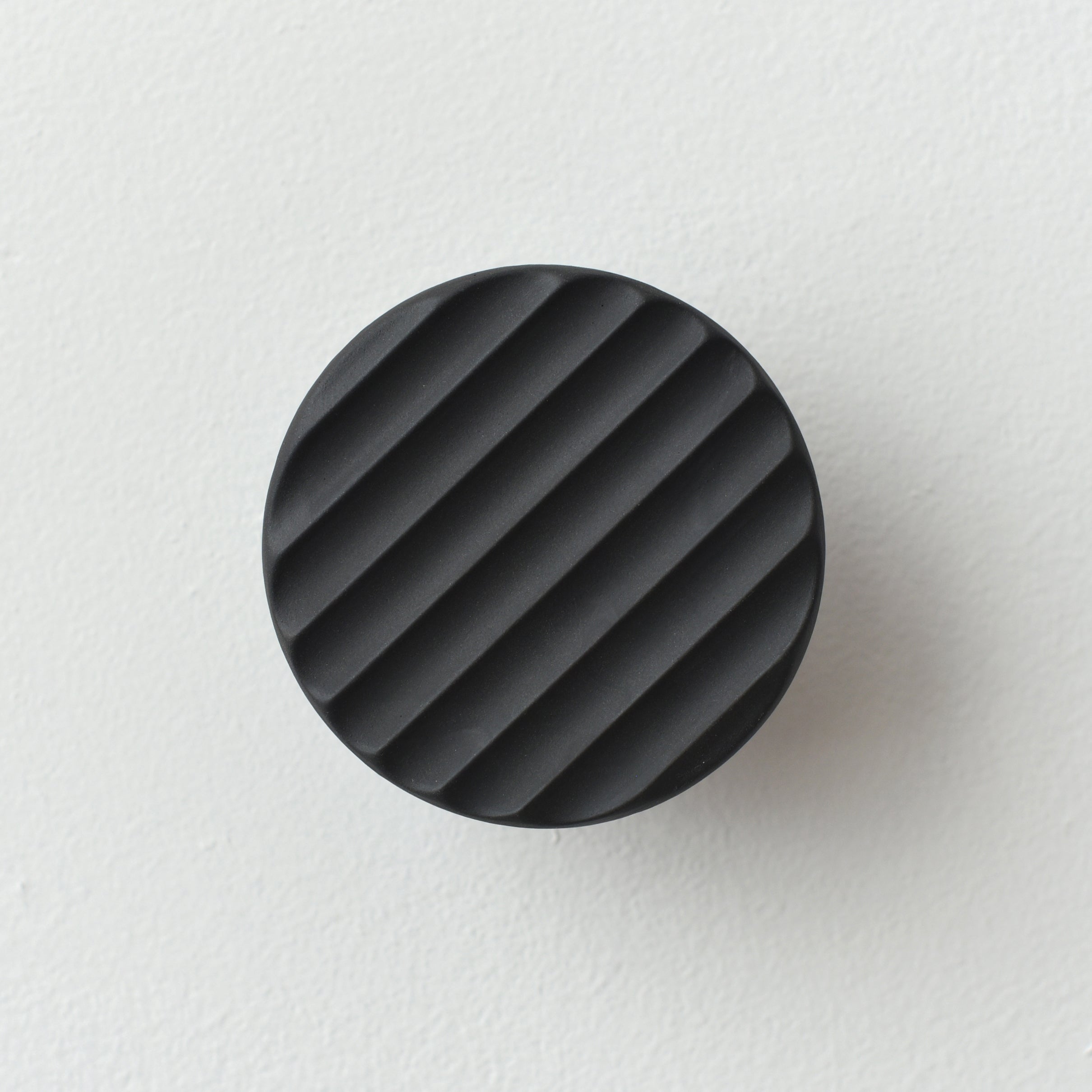 handmade ceramic coat hook in an entryway