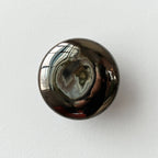 chrome ceramic coat hook in a modern entryway
